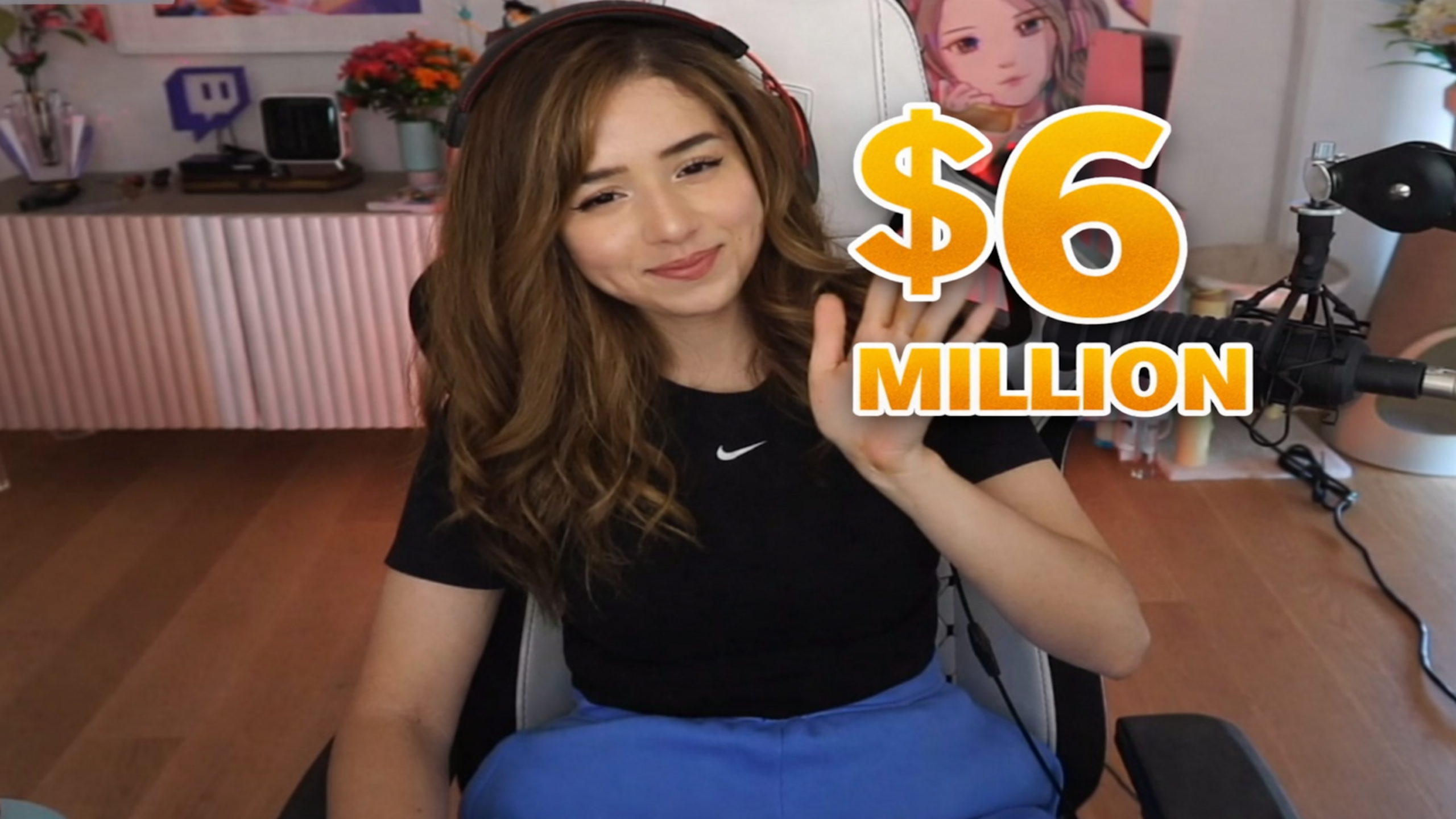 Popular female streamer waving in gaming setup with $6 million earnings from Twitch, brand deals and online content creation

