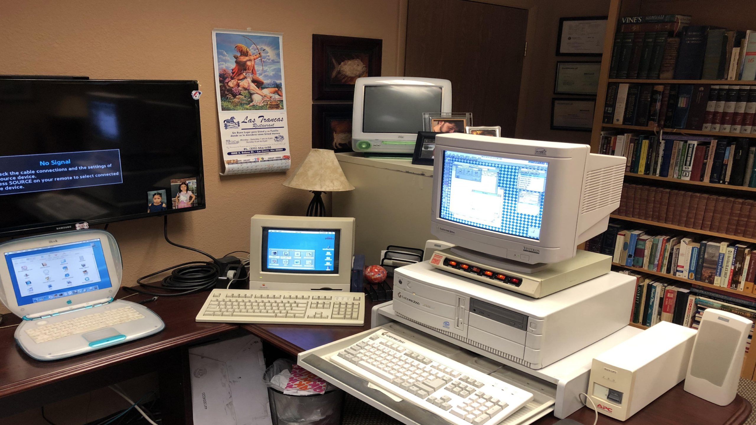 multiple retro computers setup CRT monitors old and new systems mixed desk nostalgic 2000s