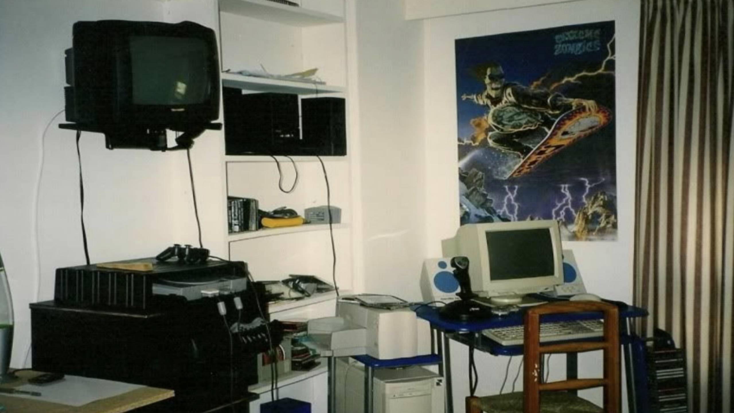 small bedroom setup CRT TV consoles joystick poster retro 2000s gaming room