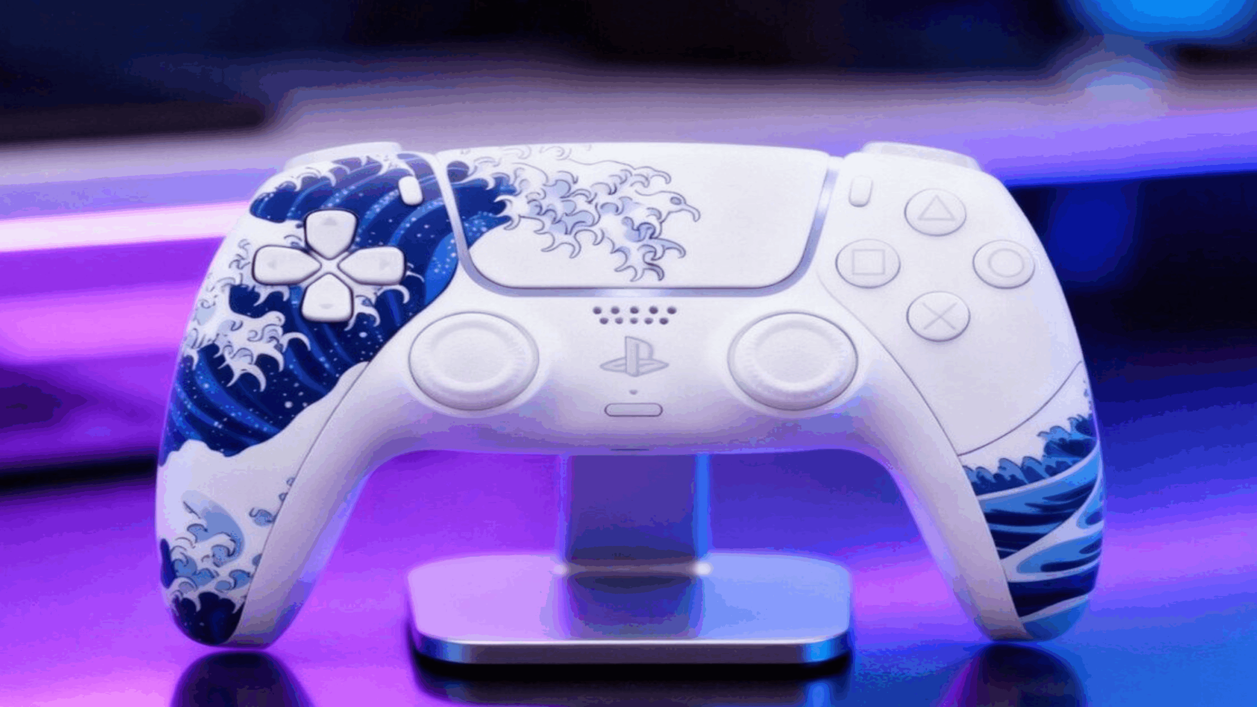 A white PlayStation controller with blue wave designs, inspired by Japanese art and embodying the elegance of expensive gaming, displayed on a stand with a purple and blue blurred background.