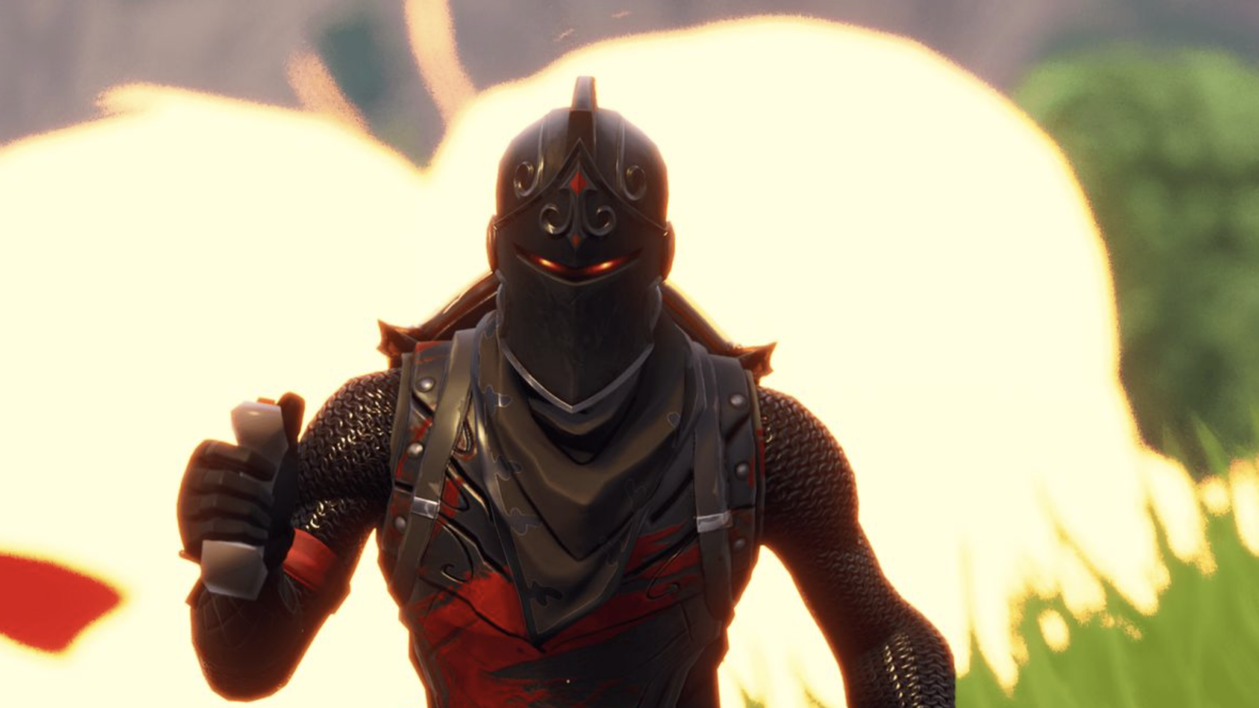 A Fortnite Skins-inspired video game character in black and red armor runs while holding an object, with a bright explosion in the blurry background and green grass beneath.
