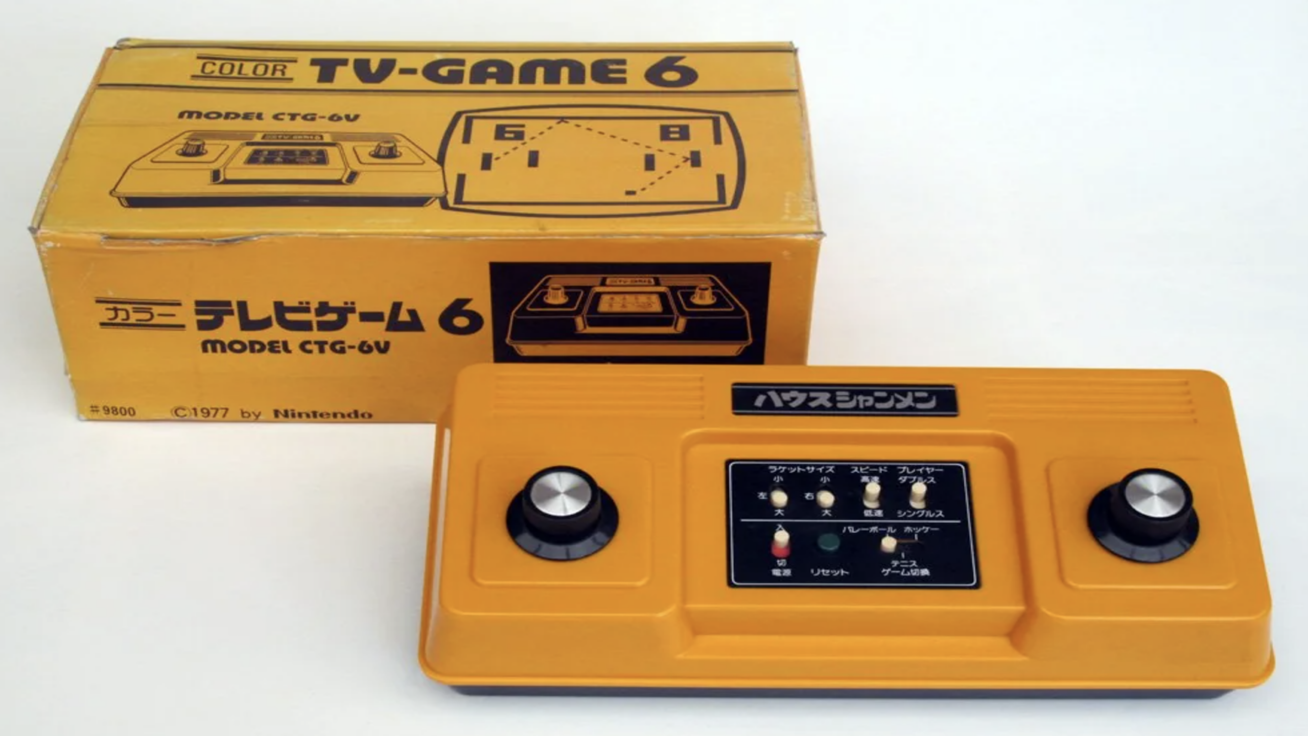 A vintage yellow Nintendo TV-Game 6 console with two black dials sits beside its matching box, which displays an image of the console and Japanese text—a remarkable piece for collectors of classic Nintendo Consoles.