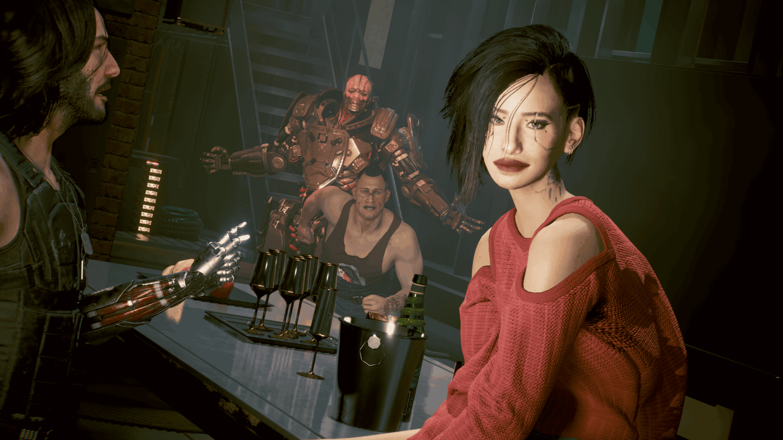 A woman in a red sweater sits at a bar, facing a man with a cybernetic arm in a scene reminiscent of GTA VI. Two other people, one with visible cybernetic enhancements, linger in the background. Four wine glasses and a bottle are arranged on the bar.