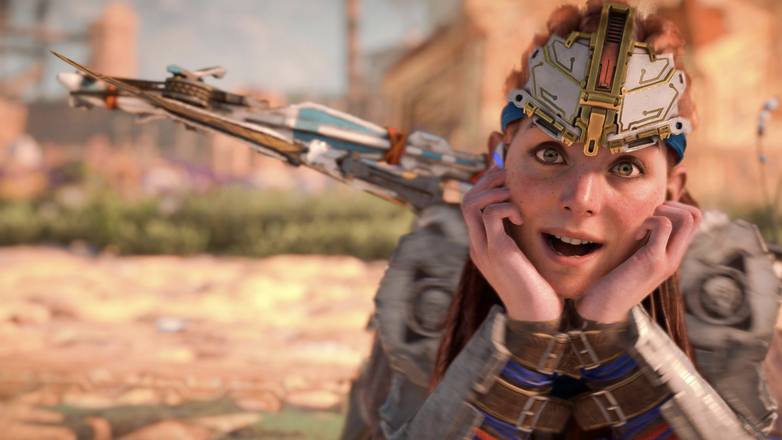 A woman in futuristic armor and a metallic headpiece rests her face in her hands, looking surprised and happy—much like a character from GTA VI discovering a new world. A high-tech bow is visible on her back. The background is blurred with a sunny, outdoor setting.
