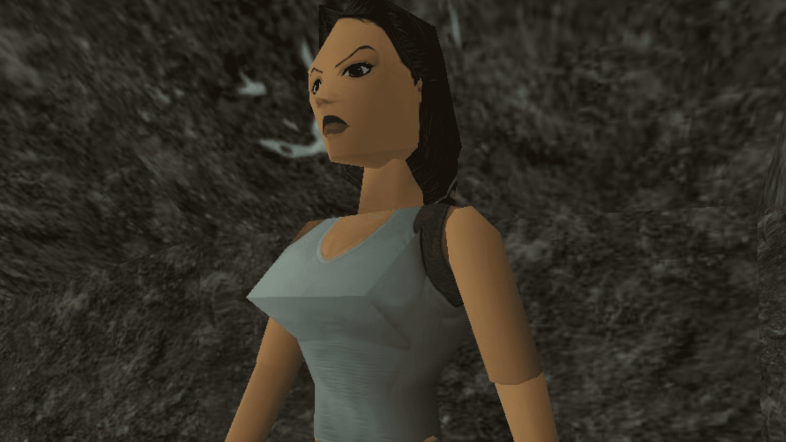A low-polygon video game character with dark hair, a light blue tank top, and a stern expression stands against a rocky, grayscale background—ready to uncover hidden video game secrets lurking in the shadows.