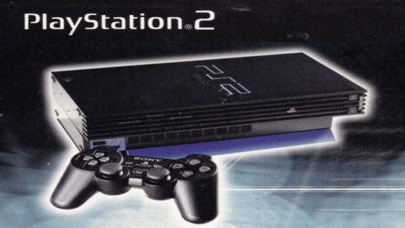A PlayStation 2 console with a black DualShock 2 controller is displayed on a dark background, showcasing the iconic PlayStation logo at the top left.