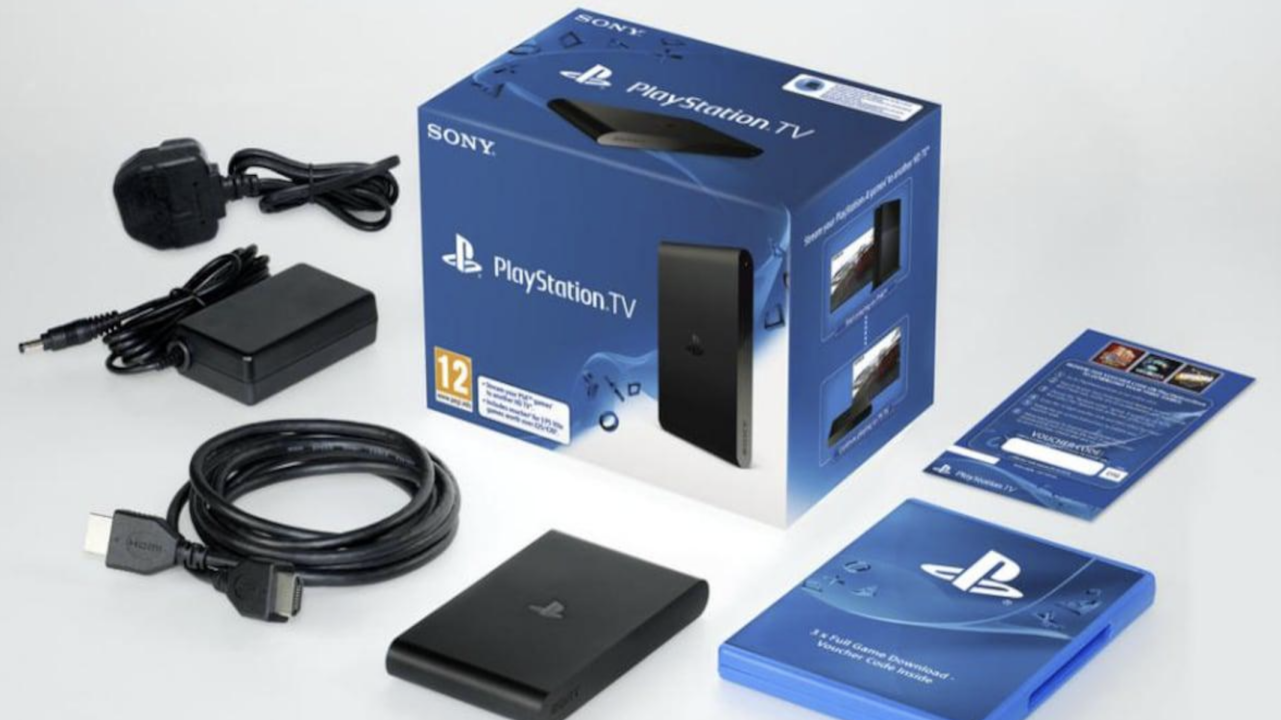 Sony PlayStation TV box and its contents, including the PlayStation console, power adapter, HDMI cable, instruction manual, and other setup accessories, displayed on a white surface.