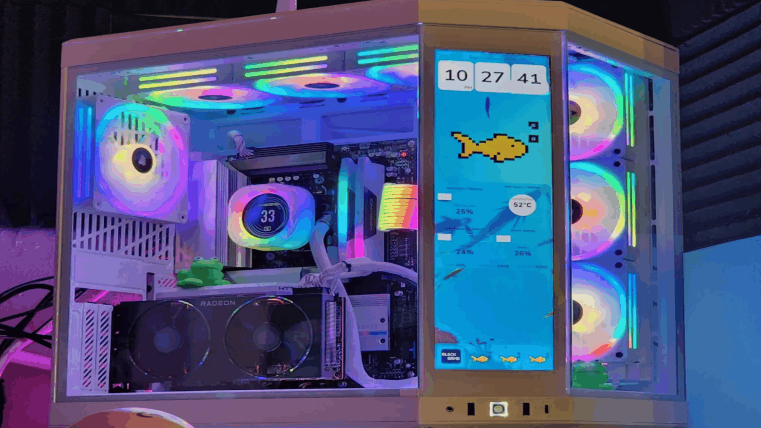 A gaming PC with colorful RGB lighting, visible internal components, and a side panel display showing system stats and a digital fish graphic—delivering an immersive experience that rivals even the latest consoles.