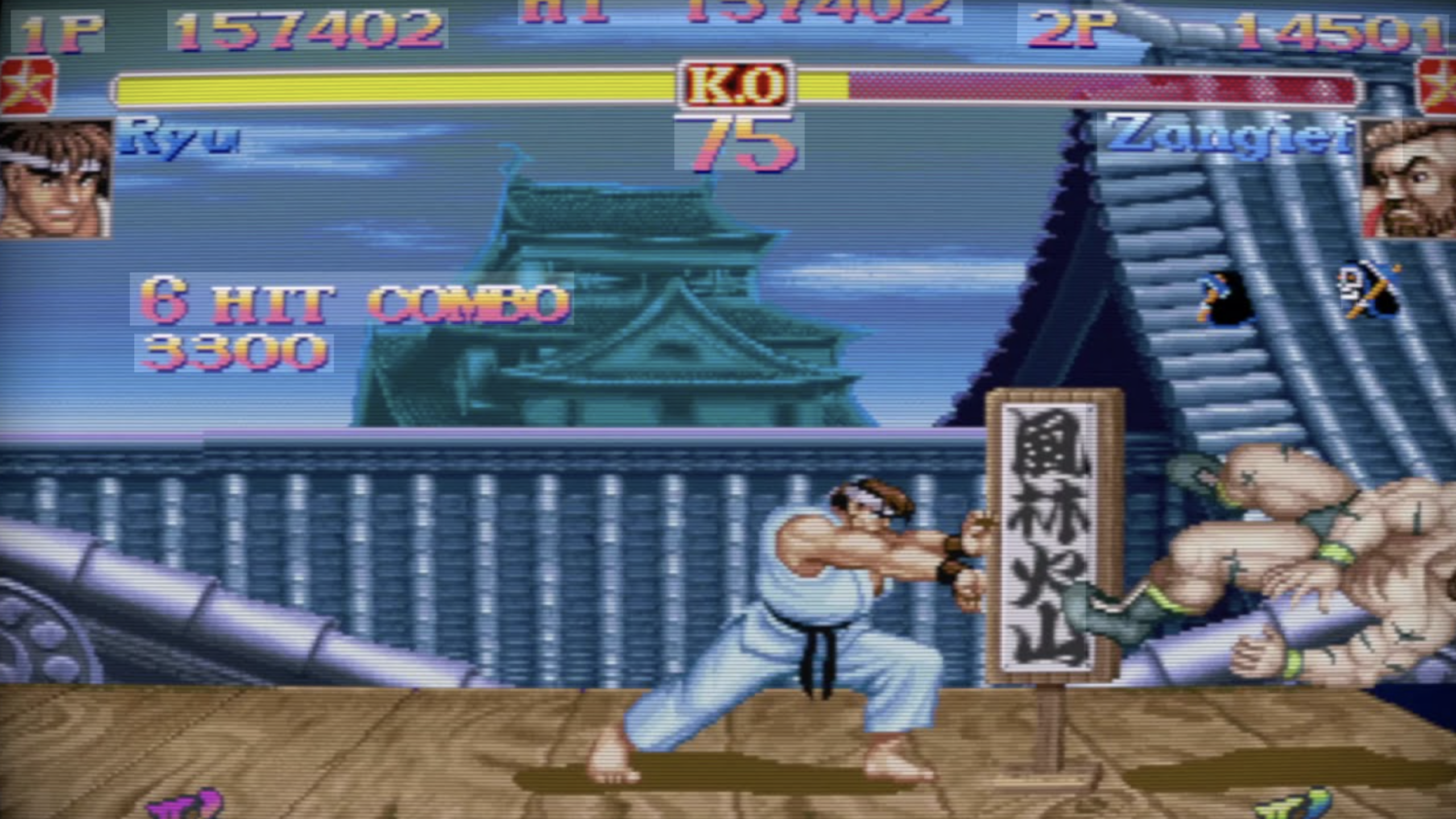 A screenshot from Street Fighter II shows Ryu performing a 6-hit combo against Zangief on a Japanese rooftop stage, with game stats and health bars displayed at the top—a classic moment that hints at the Video Game Secrets hidden within this legendary fighting title.