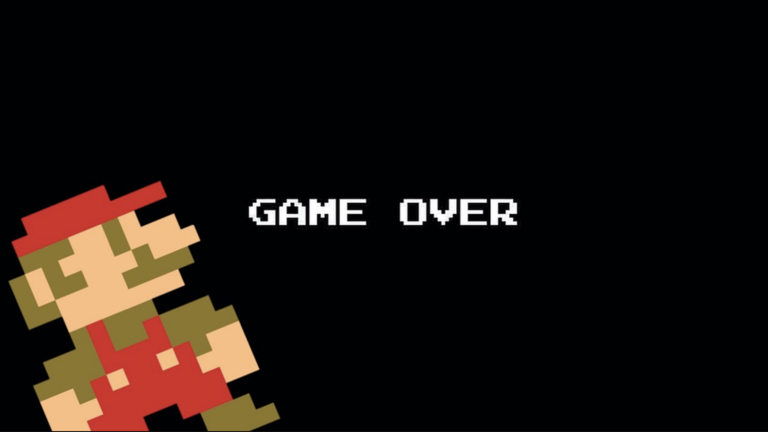 Pixelated Mario is slumped over in the bottom left corner on a black background, with "GAME OVER" in white block letters at the center.