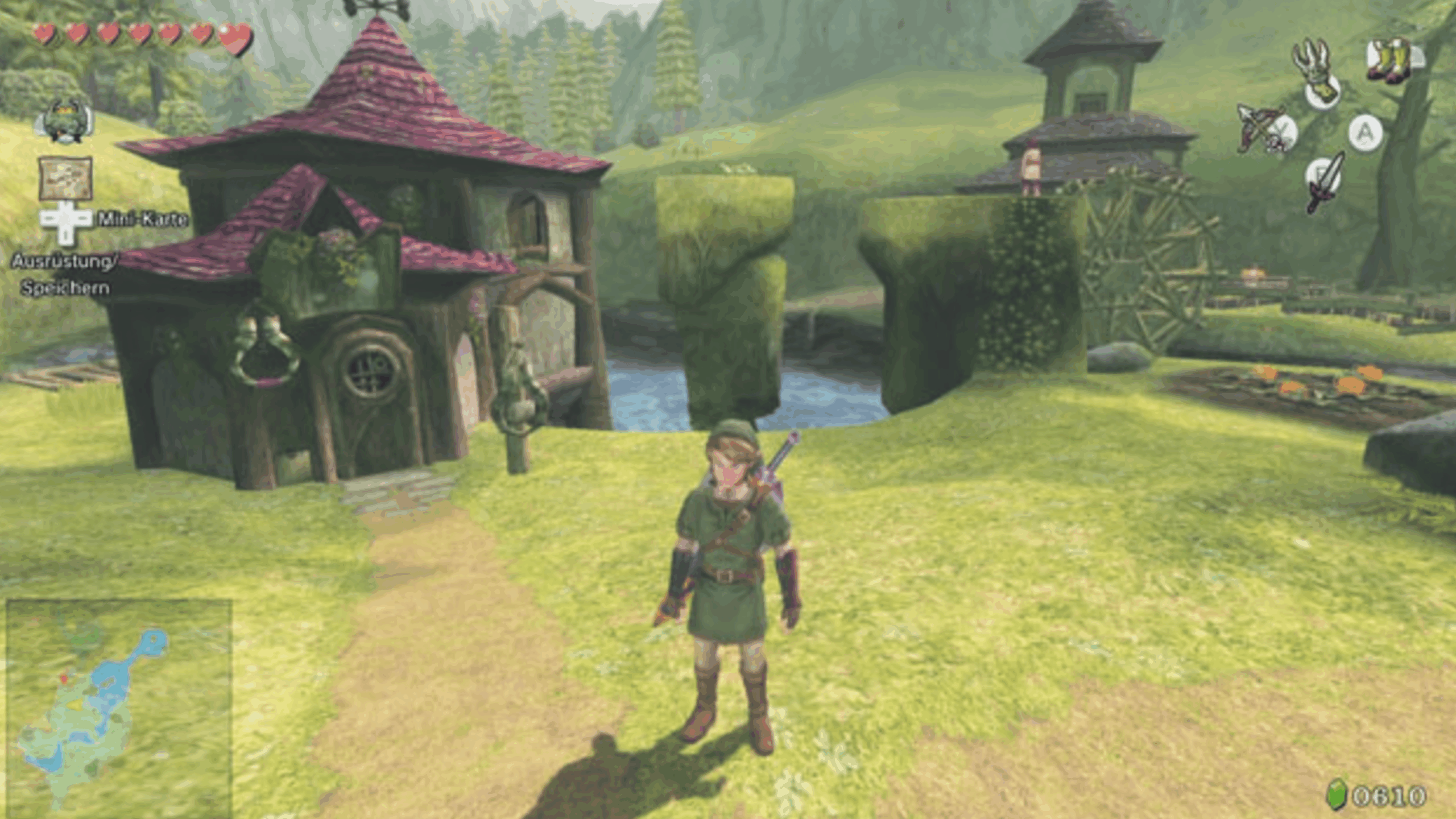 A character in green clothes stands in a sunny, grassy village with houses, a watermill, and a river—capturing the charming atmosphere often found in Zelda games. Game interface icons and a map are visible on the screen edges.