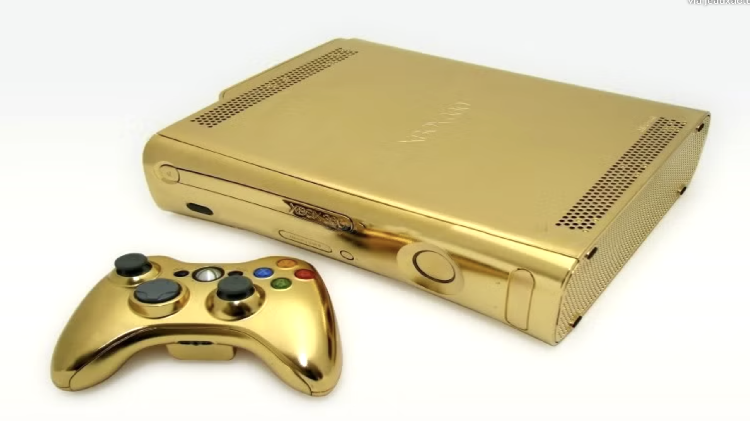 A gold-plated Xbox 360 console and matching controller are shown on a white background. Both the console and controller have a shiny metallic gold finish, making them stand out as truly luxurious gaming consoles.