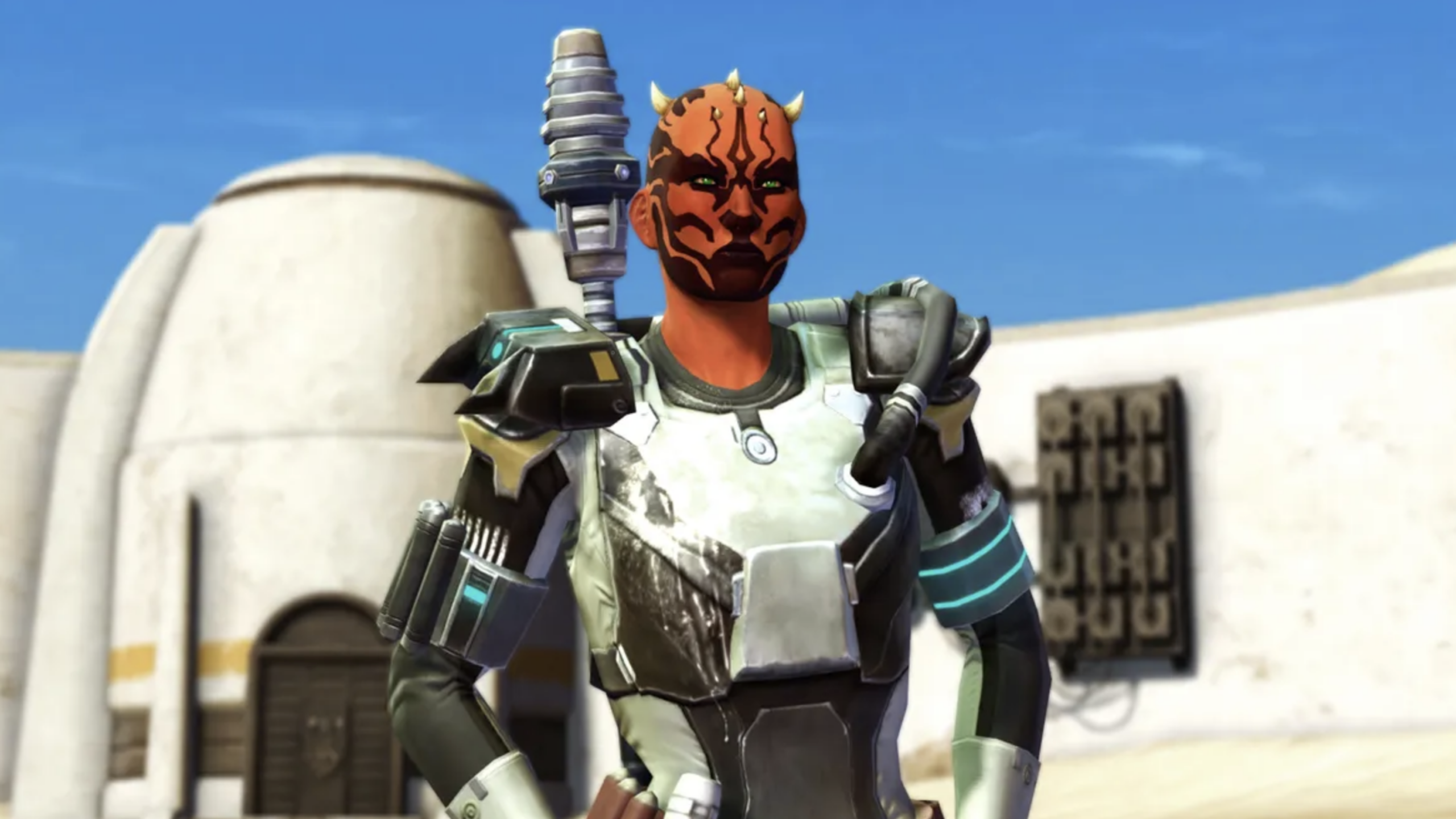 A character with red and black facial markings and small horns wears sci-fi armor, standing outdoors in front of a sand-colored building beneath a blue sky—looking as if they've stepped straight out of one of those expensive games set on distant worlds.