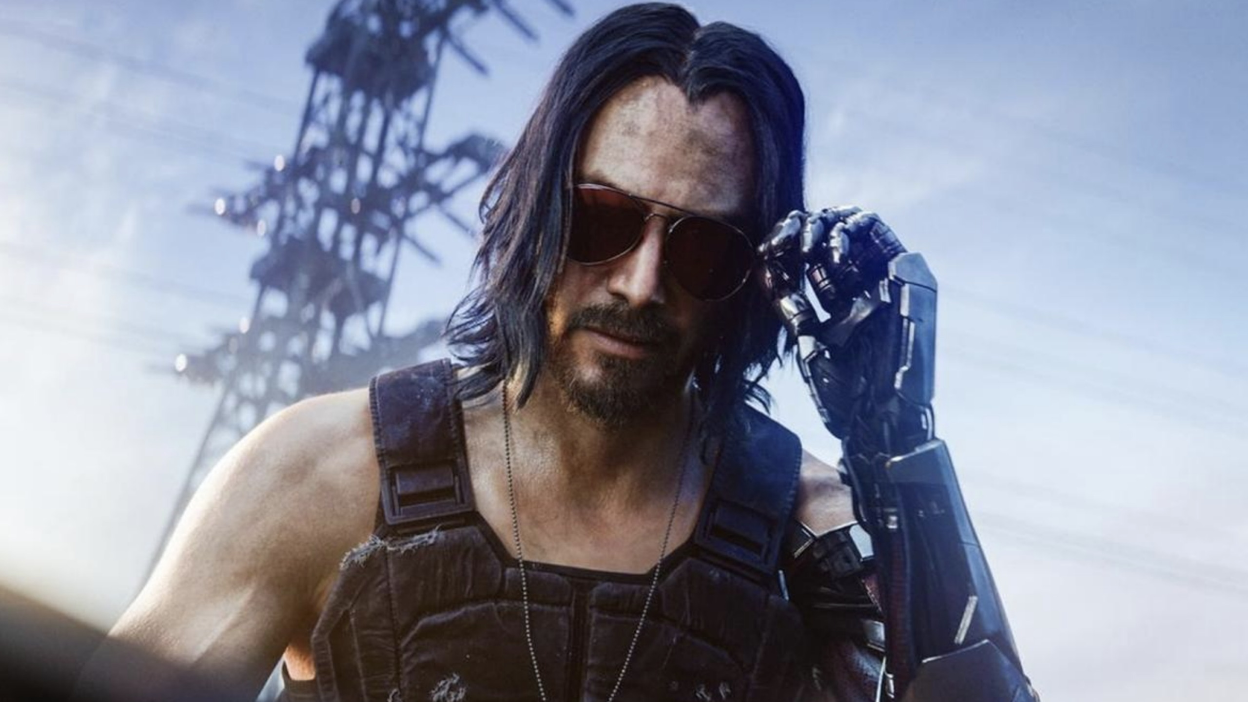 A man with long dark hair, wearing sunglasses and a tactical vest, adjusts his glasses with a cybernetic arm—resembling a character straight out of Hollywood movies. A tall, blurred structure looms in the background under a cloudy sky.