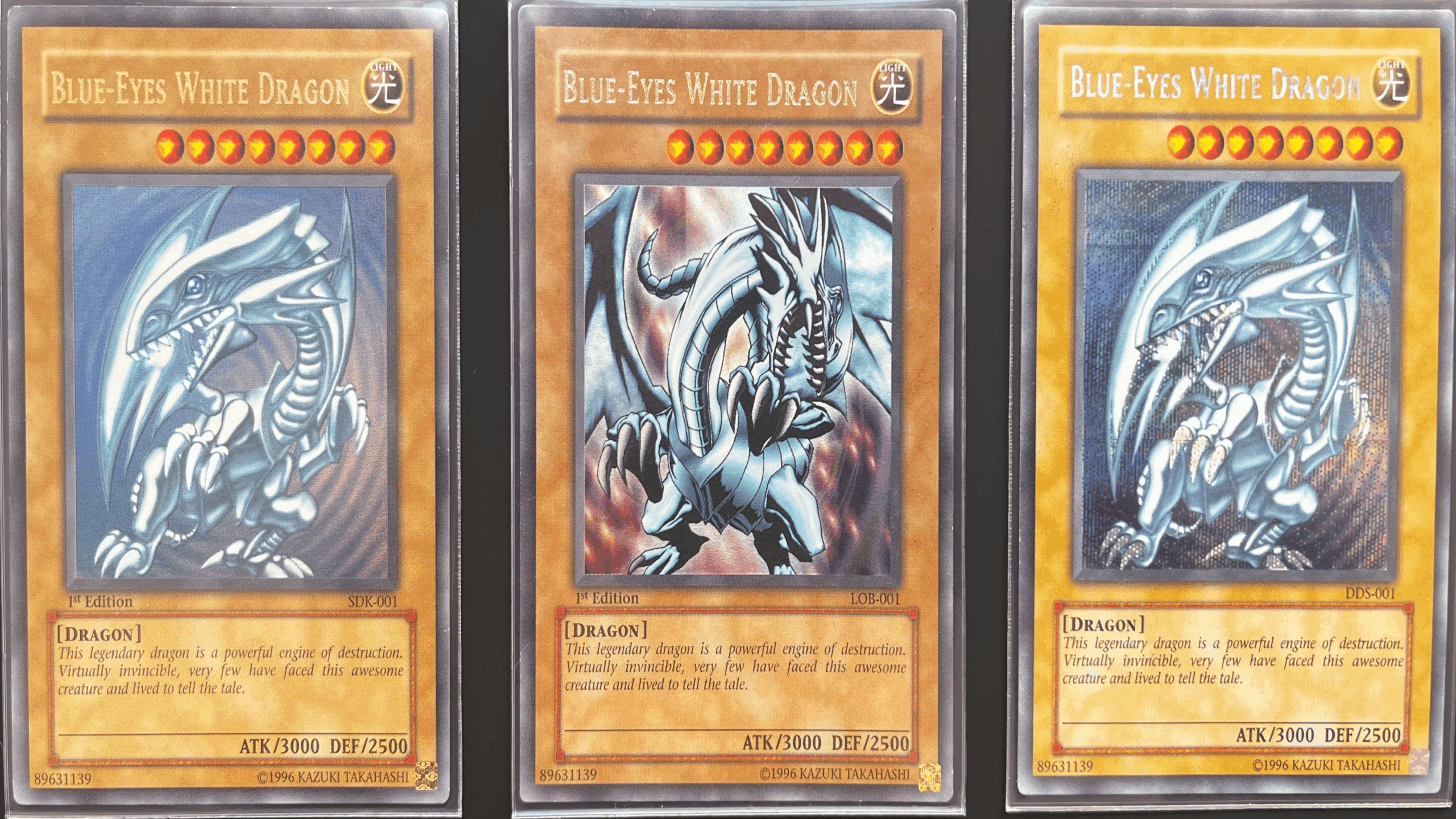 Three “Blue-Eyes White Dragon” Yu-Gi-Oh! trading cards are shown side by side, each featuring a dragon illustration with unique artwork and gold-bordered frames—a nostalgic reminder of treasured childhood items.